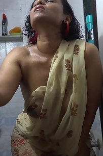 Lily in shower exposing her juicy breast in a wet see thru sari